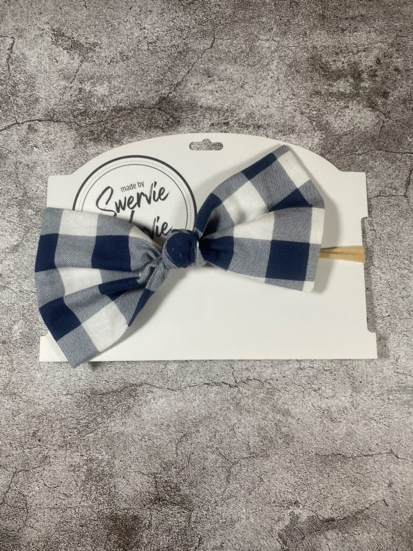 Checkered blue and white large knotted bow on a nylon headband